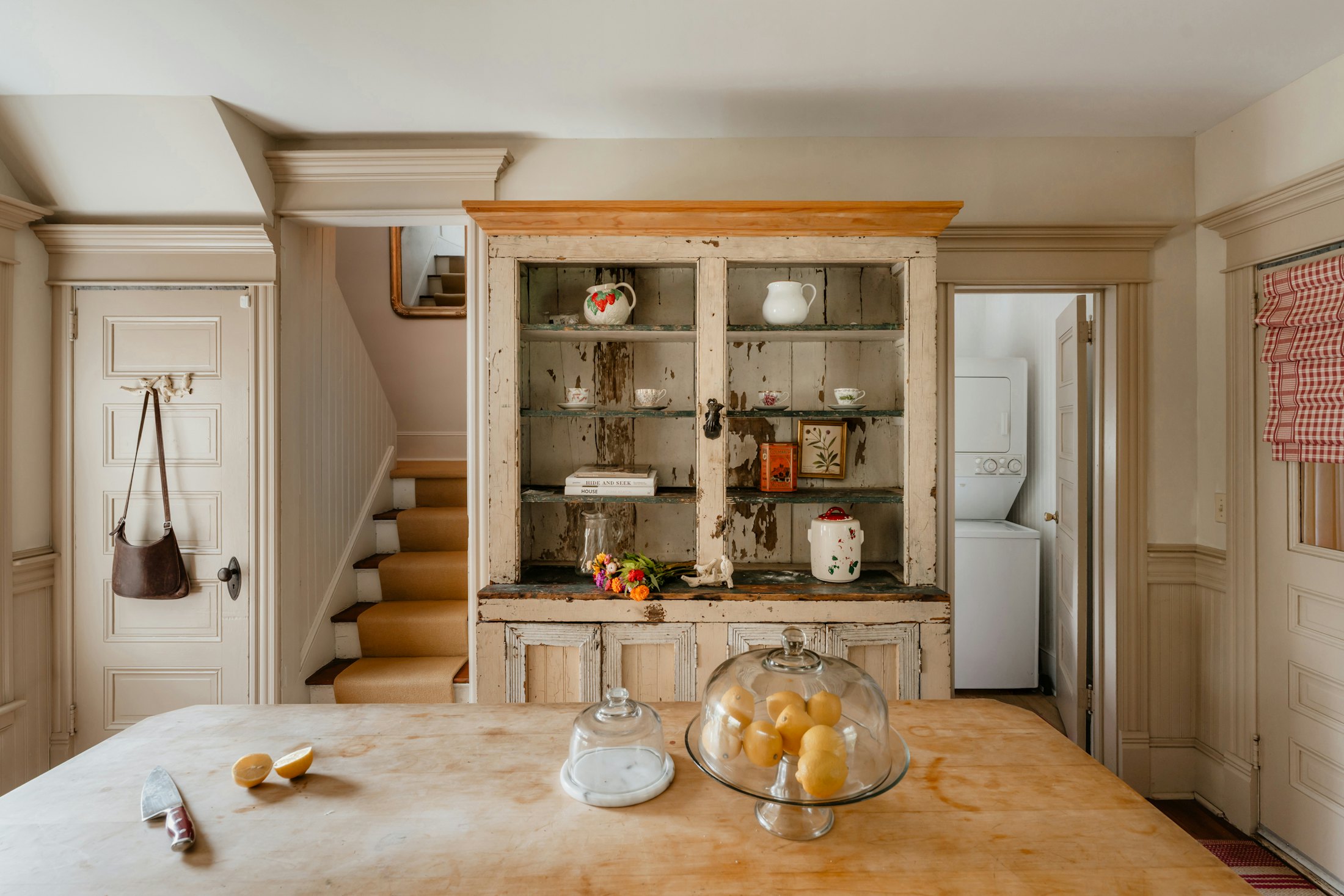 A rustic farmhouse kitchen with a wooden hutch